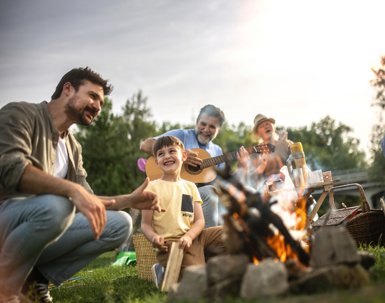 A multigenerational family is camping in nature and they make barbeque