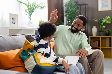 Father and son giving high five after finishing homework